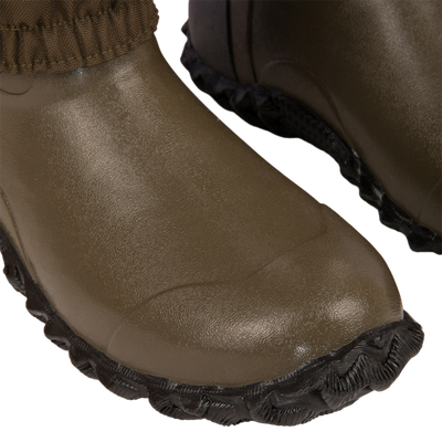 Close-up of the Hardline Insulated Breathable Wader's greenish-brown rubber toe area with black, textured soles, highlighting durability and comfort for outdoor adventures.