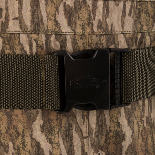Close-up of a quick-release buckle on the Hardline Insulated Breathable Wader, showcasing durable, camouflaged fabric, part of Drake Waterfowl's high-quality hunting gear.