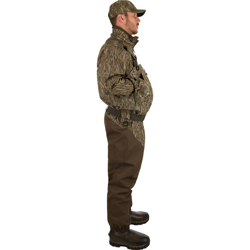 Uninsulated Guardian Elite HND Front Zip Waders - Green Timber: A man in camouflage clothing wearing the durable, comfortable waders with improved boots and front zipper.