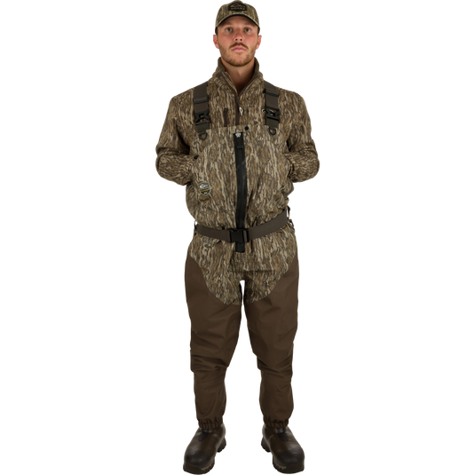 Uninsulated Guardian Elite HND Front Zip Waders - Habitat: A man in camouflage outfit wearing military-style waders with front zipper, standing confidently in the outdoors.