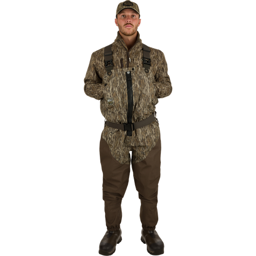 Uninsulated Guardian Elite HND Front Zip Waders - Green Timber: A man in a camouflage outfit wearing military-style waders with a front zipper.