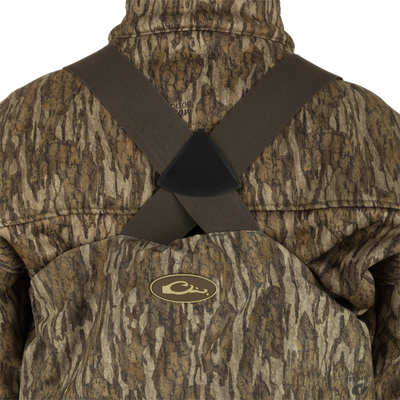 A person wearing the Guardian Elite Hybrid Insulated Front Zip Wader, showcasing its advanced features and camouflage design for serious outdoorsmen.