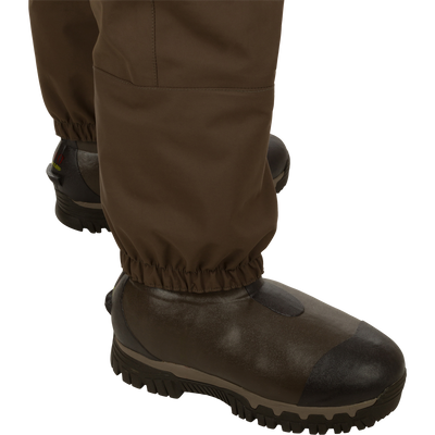 Insulated Guardian Elite HND Front Zip Wader with brown boots, featuring a waterproof vertical zipper and reinforced seams for durability and comfort in cold weather.