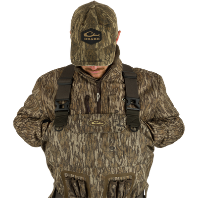A person wearing Uninsulated Guardian Elite Vanguard Breathable Waders showcasing pass-through internal handwarmer pockets