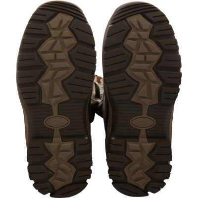Sole-up view of BMF1600 Kevlar Wader boots, showcasing camo-patterned, heavy-tread design for superior grip and durability in hunting and outdoor activities.
