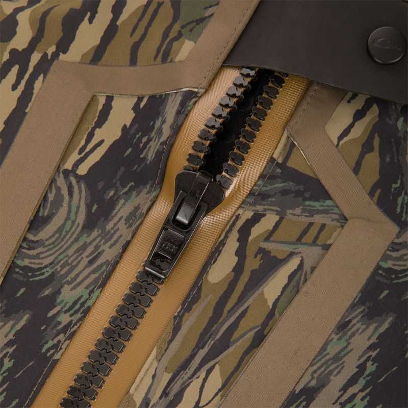 Close-up of BMF1600 Kevlar Wader's tiger-stripe camouflage fabric, showcasing its durable two-way zipper with tan seam taping and storm flap for water resistance.
