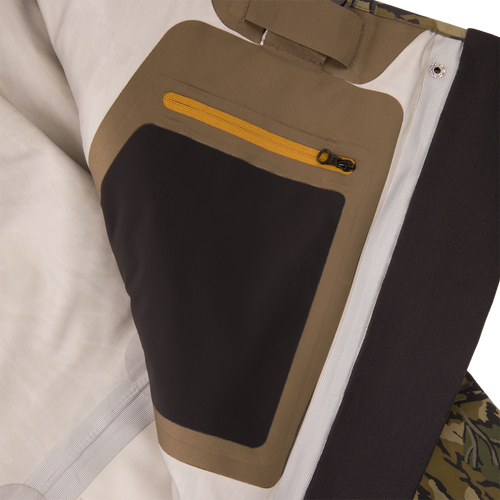 Inner panel of the BMF1600 Kevlar Wader with Primaloft, featuring off-white, tan, and black lining, yellow zip pocket, and camo fabric edge.