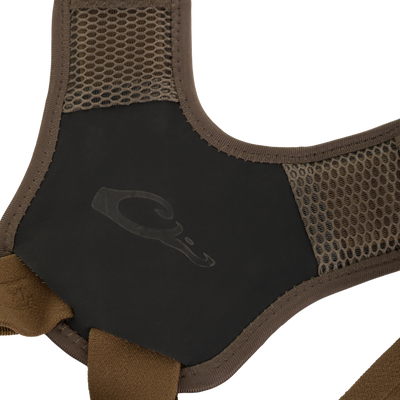 Close-up of brown mesh shoulder straps on a Drake X Ducks Unlimited BMF1600 Kevlar Wader, connected to a black chest panel with a duck head logo.