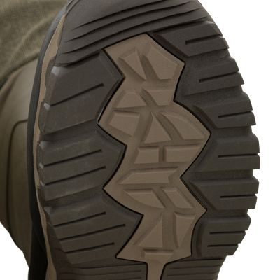The treaded rubber sole of an olive-green Drake X Ducks Unlimited BMF1600 Kevlar Wader boot.