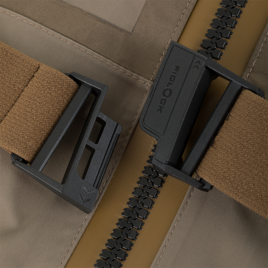 Close-up of a tan Kevlar wader chest strap with a black magnetic Fidlock buckle on the Drake X Ducks Unlimited BMF1600 Kevlar Wader.