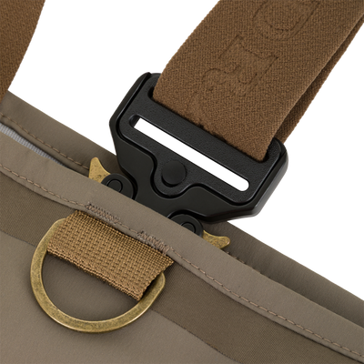Close-up of a brown Drake X Ducks Unlimited BMF1600 Kevlar Wader strap attached to a black buckle and a brass D-ring.