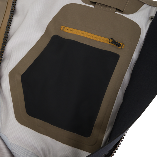 Interior view of a Drake X Ducks Unlimited BMF1600 Kevlar Wader chest showing a large black pocket with a tan border and a small zippered compartment above it.