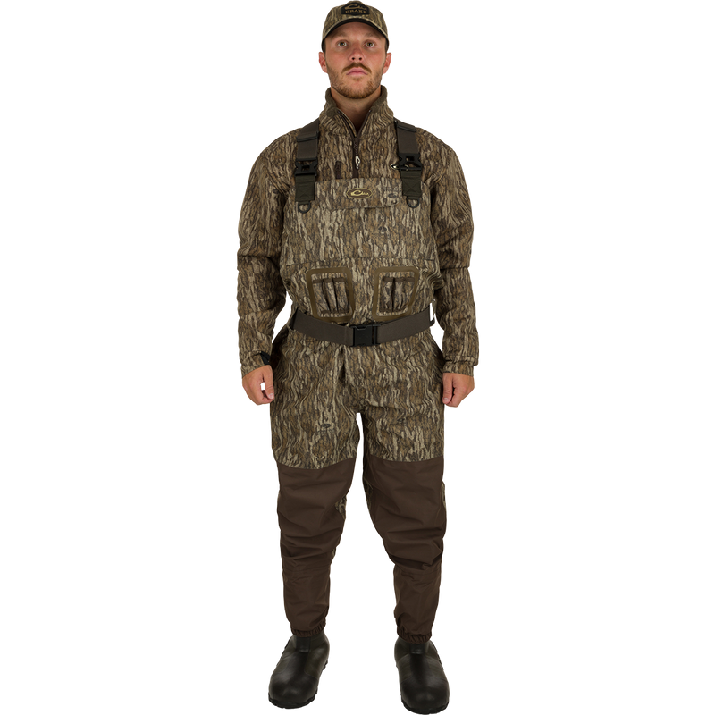 A man in camouflage uniform wearing Insulated Guardian Elite Vanguard Breathable Waders - Realtree.