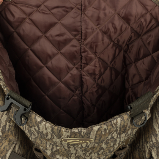 A close-up of the Insulated Guardian Elite Vanguard Breathable Waders - Realtree, featuring a camouflage backpack with a brown lining and a black plastic buckle.