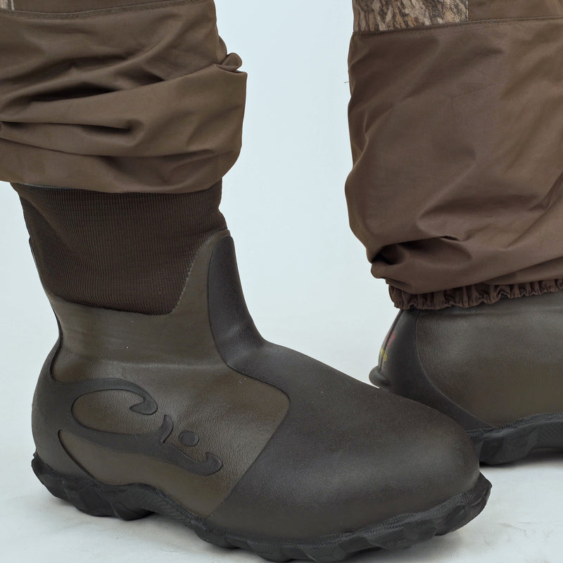 Boot close-up. Insulated Breathable Chest Wader with Sewn-in Liner for hunters by Drake Waterfowl. Features LokDown insulation, HD2 protection, and 1200g Thinsulate Buckshot Mud Boot. Durable and versatile hunting gear.