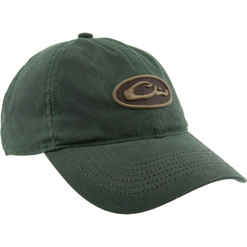 Box Waxed Canvas Cap on mannequin head, featuring a brown and tan Drake Waterfowl logo patch, curved bill, and adjustable brass slide closure.