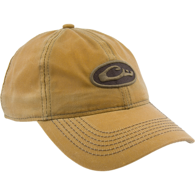 Box Waxed Canvas Cap with mid-profile, six-panel design, featuring an embroidered Drake logo patch and adjustable brass slide closure, displayed on a mannequin head.