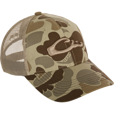 A 6-panel camo mesh-back cap made from 100% cotton. Features low-profile construction, lightly structured front panels, and a secure hook & loop back closure. Includes the Drake 
