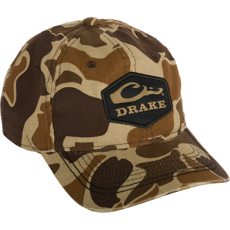 A Women's Camo Ponytail Cap with a black logo, perfect for tackling any terrain in style. Made from a lightweight blend of cotton and polyester, this low-profile cap features unstructured front panels and a secure hook-and-loop closure. The added ponytail slot allows for freedom of movement. Get ready to take on any challenge with confidence!