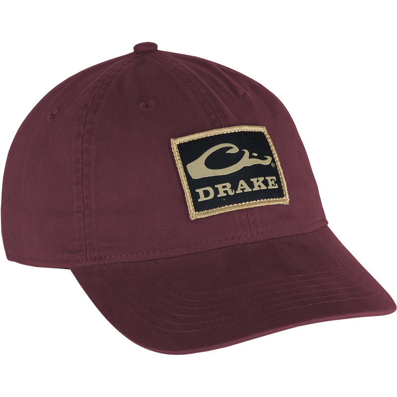 Cotton Twill Patch Cap with a red logo on a low profile hat. Features a contoured bill and brass buckle back strap for a comfy fit. 