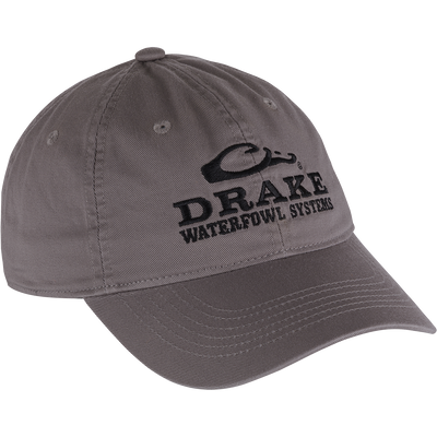 Cotton Twill Systems Cap: Grey, low-profile baseball cap with black text and brass buckle backstrap, designed for comfort and style in outdoor settings.