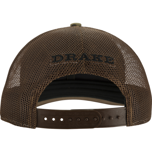 A close-up of the Oval Patch Ranger Camo Mesh Back Cap, featuring a brown hat with a black text and a woven fabric detail.