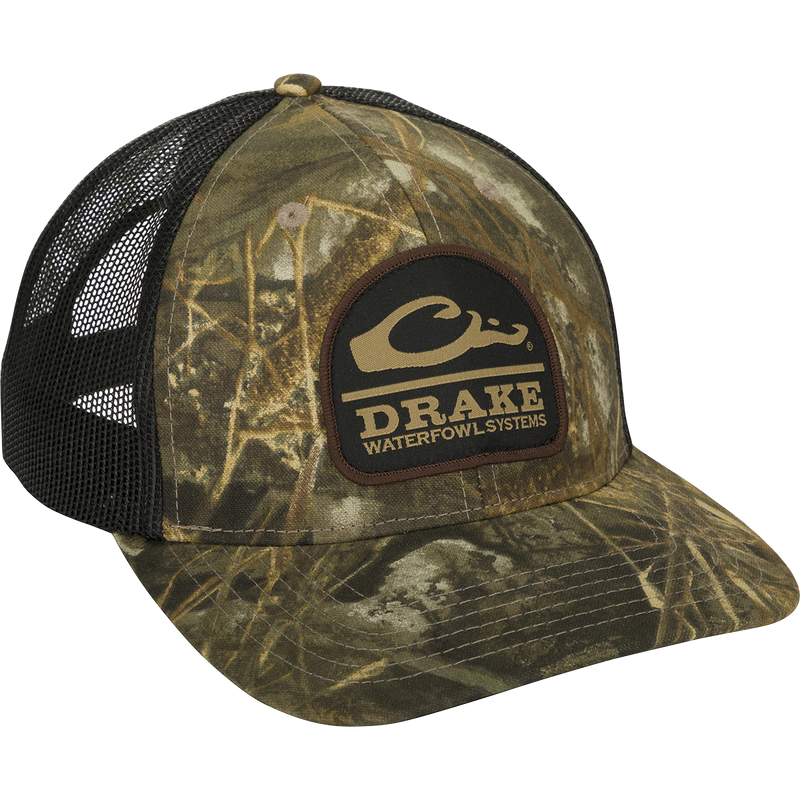 A black mesh cap with a logo patch close-up. Quality hunting gear for big game, waterfowl, and turkey hunting.