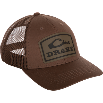 A brown Drake Badge Logo Mesh Cap with a logo on it.