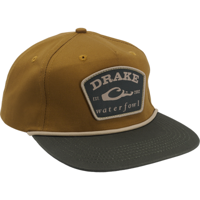 Drake X Lost Hat Drake Patch Goat Rope Cap with tan crown, olive bill, sewn patch, adjustable snap-back, and flat visor, blending comfort and structure.