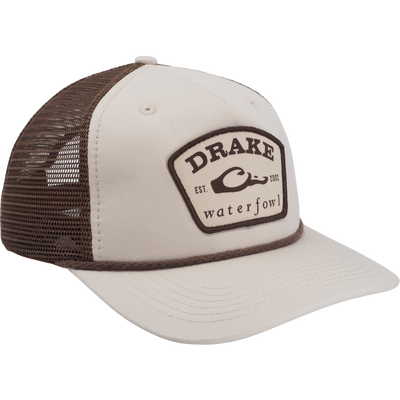 Beige-and-brown mesh-back trucker cap with DRAKE waterfowl EST. 2002 patch, featuring a durable 60/40 cotton-poly blend and Western-inspired styling.
