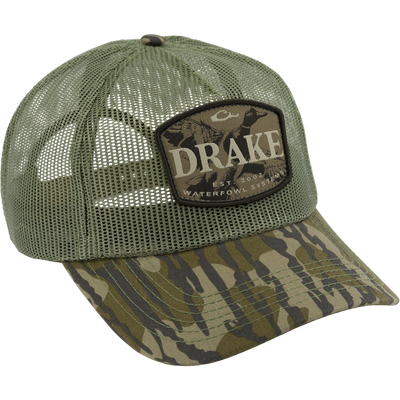 Drake x Lost Hat Ea5y Meshed Trucker Cap with woodland camo front, olive mesh back, and Drake Waterfowl Systems patch, designed for outdoor comfort.