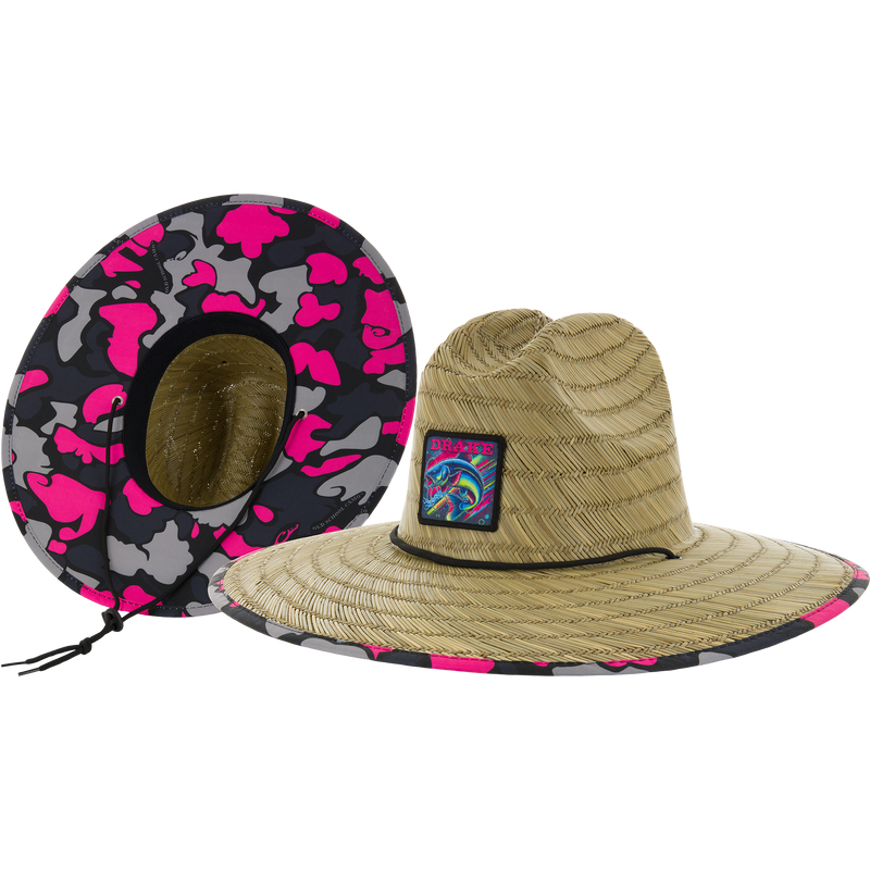 Drake X Lost Lake Shore Straw Hat featuring a wide-brimmed straw design with a colorful patch and pink-gray camo lining, showcasing adjustable chin cord for secure fit.