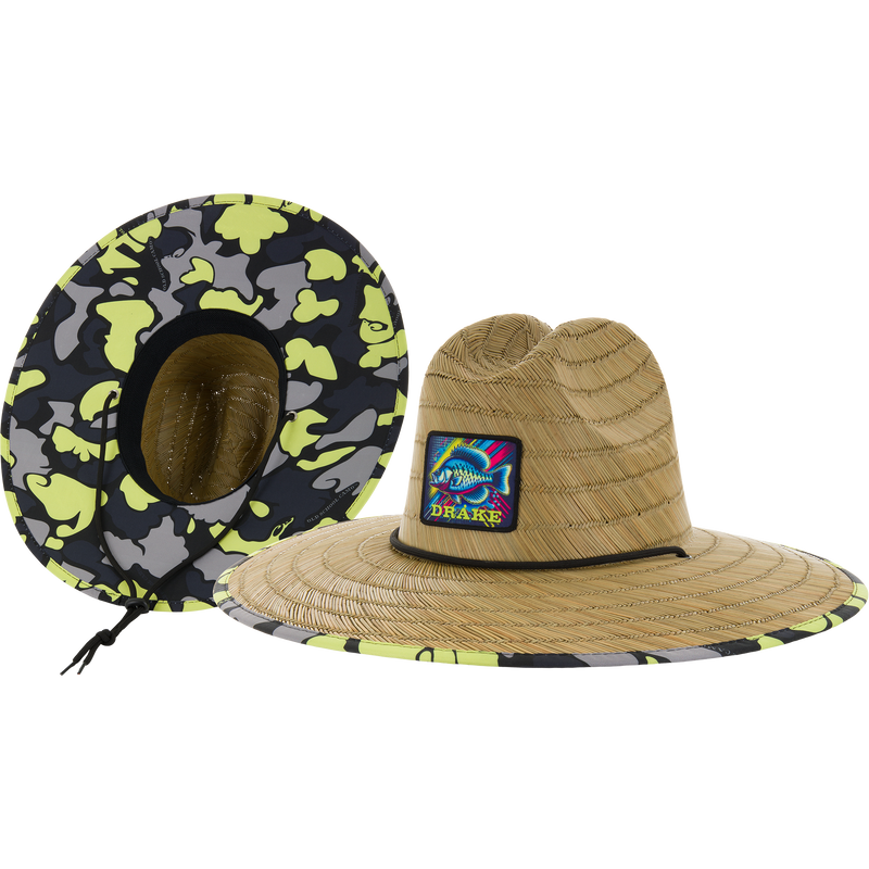 Drake X Lost Lake Shore Straw Hat featuring a camo under-brim and chin cord, highlighting a fish graphic patch with DRAKE on woven straw.