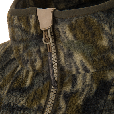 Non-Typical Statix Sherpa Fleece Insulated Jacket features a woolly collar, olive-green binding, and a chunky tan zipper, showcasing its rugged design for hunting.