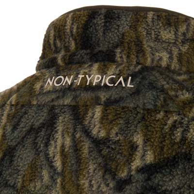 Non-Typical Statix Sherpa Fleece Insulated Jacket's fuzzy camouflage bucket hat, featuring NON-TYPICAL text, showcases rugged, weatherproof design for hunting in harsh conditions.