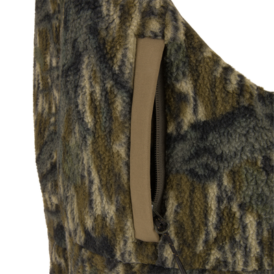Non-Typical Statix Fleece Lined Bib with Agion Active X2, showcasing woolly fleece texture, camouflage pattern, zippered pocket with contrasting trim, and drawcord toggle for rugged hunting use.