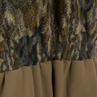 Close-up of Non-Typical Statix Fleece Lined Bib's olive fleece and tan pleated fabric, showcasing its warmth and durability for extreme hunting conditions.