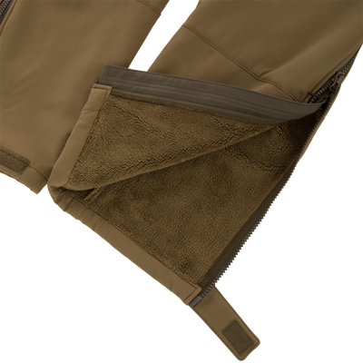Close-up of the Non-Typical Statix Fleece Lined Bib, showcasing the olive-green softshell with sherpa fleece lining, zipper, and Velcro cuff strap for hunting in extreme conditions.