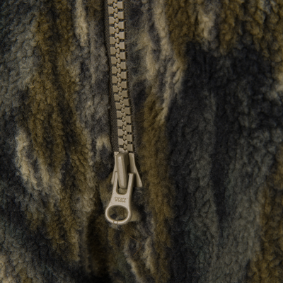 Close-up of a YKK zipper on the Non-Typical Statix Fleece Lined Bib, showcasing its plush sherpa fleece texture for extreme cold protection.