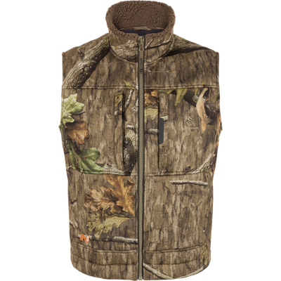 Midweight Nova Silencer Vest with Agion Active X2, featuring woodland camo, fleece-lined collar, zip pockets, quilted panels, and safety harness opening for warmth and concealment.