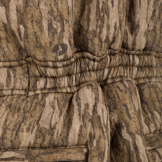 Midweight Nova Silencer Bib with Scent Control, featuring a quilted camouflage pattern, ruched waist, hanging belt, and logo. Ideal for silent, warm, and water-resistant outdoor adventures.