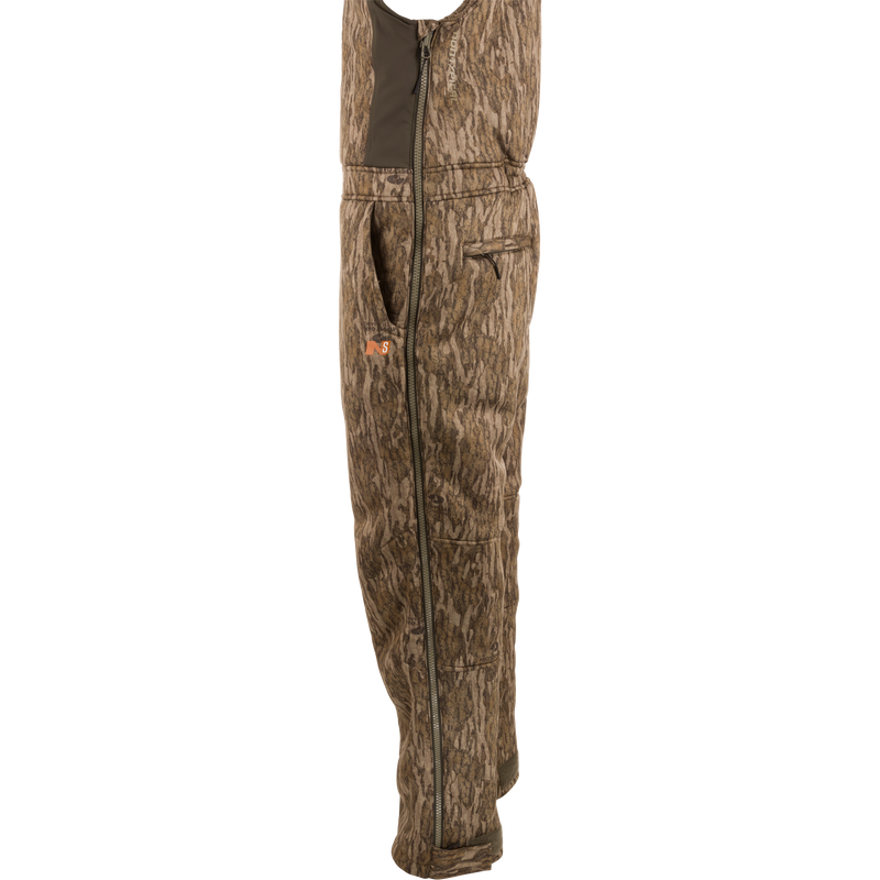 Midweight Nova Silencer Bib with Scent Control, featuring adjustable straps, full-length side zippers, and multiple pockets, designed for warmth and quiet during outdoor hunting.