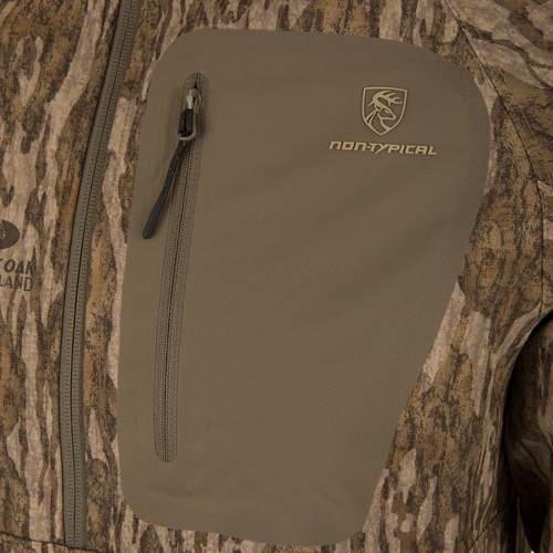 Close-up of the Non-Typical SWT Hybrid Half Zip with Scent Control, showing the camo pattern, logo, and zip chest pocket designed for hunting durability.