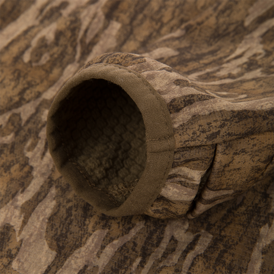 Close-up of the Non-Typical SWT Hybrid Half Zip sleeve, showcasing camouflage pattern and honeycomb-textured lining, designed for optimal breathability and scent control.
