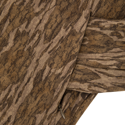 Close-up of the Non-Typical SWT Hybrid Half Zip, highlighting the camouflage fabric and water-resistant zippered pocket, ideal for hunting with scent control technology.