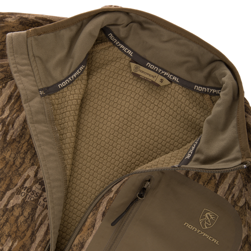 Non-Typical SWT Hybrid Half Zip jacket in Mossy Oak Bottomland pattern, featuring waffle-weave lining, branded details, and ergonomic design for enhanced breathability and scent control.