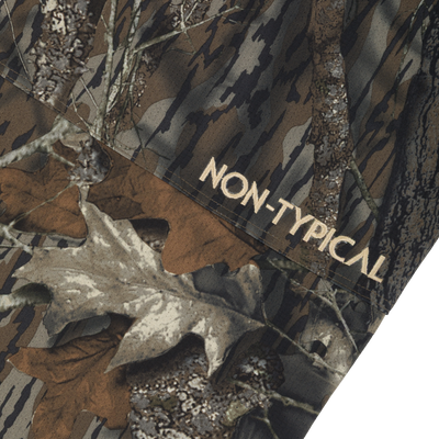Close-up of Non-Typical SWT Pant with Scent Control, showcasing camo fabric and embroidered label, highlighting its durable, quiet, and water-resistant material.