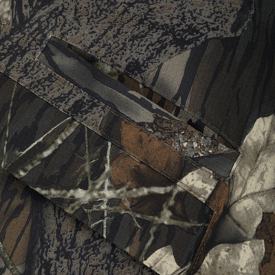 Close-up of Non-Typical SWT Pant with Scent Control, showcasing camouflage fabric with sewn-on pocket panels and stitching, ideal for hunting with advanced odor and water resistance.