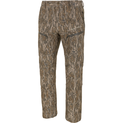 Non-Typical Pursuit Softshell Pant with Agion Active X2 hunting pants in Mossy Oak Bottomland tree bark camouflage, featuring a windproof, water-resistant design with zippered pockets and logo text on the thigh.