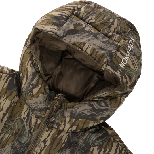 A close-up of the Non-Typical Down Jacket with Agion Active X2 by Nontypical, featuring a green, brown, and gray camo pattern. The hood is up with “NON-TYPICAL” printed in white on the edge.